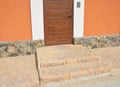 Entrance house doorway with steps and wild stone foundation wall