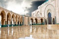 Entrance King Hassan II Mosque, Casablanca, reflecting in puddle.