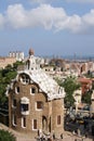 Entrance lodge to Parc Guell designed by Antoni Gaudi, UNESCO, with a skyline view of the city of Barcelona, Catalonia, Spain