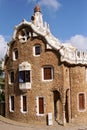 Entrance lodge to Parc Guell designed by Antoni Gaudi, UNESCO, with a skyline view of the city of Barcelona, Catalonia, Spain