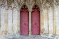 The entrance or main doors to an old English cathedral designed in the Gothic style