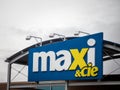 Entrance of a Maxi & Cie Supermarket with its logo. Belonging to the group Loblaw, Maxi Supermarkets is the leader in mass market