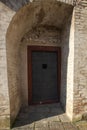 Entrance metal door to the basement. There is a wall around