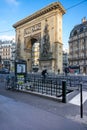 Entrance of the metro and old Saint-Denis gate, vestige of the ramparts of the walls of Paris