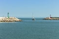 The entrance of Pesaro harbour with tetrapod breakwaters, and a green and a red lighthouse on the piers Italy, Europe Royalty Free Stock Photo