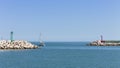 The entrance of Pesaro harbour with tetrapod breakwaters, and a green and a red lighthouse on the piers Italy, Europe Royalty Free Stock Photo