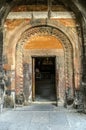 The entrance to the Temple of the Most Holy Theotokos is framed by a patterned arched cornice in the Khor Virap fortress. Royalty Free Stock Photo