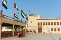 Entrance of the Ras al Khaimah Museum in the morning sun with flags blowing Royalty Free Stock Photo