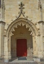 Entrance with red door at gothic style catholic church Royalty Free Stock Photo