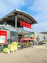 Entrance of a REWE supermarket in Germany in sunny weather