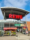 Entrance of a REWE supermarket in Germany in sunny weather