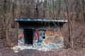 Entrance to abandoned concrete bunker built during the Second World War right in a hill near the center of Vilnius. Walls painted