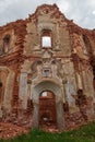 The entrance to the abandoned ruined old church is made of brick with crumbling plaster. Outside view. Russia, Smolensk region, Royalty Free Stock Photo