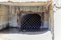 entrance to an abandoned tunnel closed with a metal grate Royalty Free Stock Photo