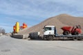 Truck, silos and sand heaps.