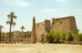 Entrance to the ancient temple of the Pharaohs Karnak, Luxor, Egypt. Statues on the sides and obelisk on center. Royalty Free Stock Photo