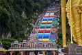 Entrance to Batu Caves with the giant, golden Murugan statue and the 272-step colorful staircase