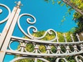 Entrance to the botanic garden in Tbilisi. Beautiful iron gate against the blue sky. Summer day in the city Royalty Free Stock Photo
