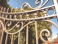 Entrance to the botanic garden in Tbilisi. Beautiful iron gate against the blue sky. Summer day in the city Royalty Free Stock Photo