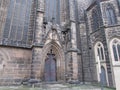 The entrance to the building of the Catholic Gothic cathedral, arches, crosses in the ornament.