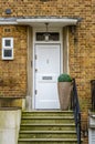 The entrance to a building stone steps on the right side of the