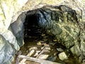 Entrance to a cave in an old industrial excavation Royalty Free Stock Photo