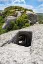 Entrance to the cave on top of a mountain. The sharp descent down the tunnel