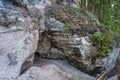 Entrance to the cave. Tourist trail near sandstone cliffs.