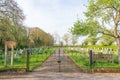 Entrance to cemetery showing front gates with park bench and trees. Hertfordshire. UK Royalty Free Stock Photo