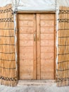 Entrance to a Central Asian gazebo called a Yurt made of yellow dried reeds