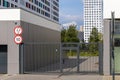 Entrance to the courtyard of a modern multi-storey residential complex. Lattice gates with a wicket and an entrance