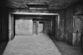 The entrance to the dark dungeon with walls of large concrete blocks and a ceiling of monolithic reinforced concrete, made in the