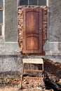 Entrance to destroyed building, wooden door, metal staircase, wi Royalty Free Stock Photo