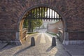 The entrance to the gate of the old castle. The road from pavement, fences from unwanted intrusion - fence and gates at dawn, soft Royalty Free Stock Photo