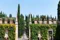 Entrance to Giusti garden. Closed gate. Cypress trees and brick towers in Verona, Italy Royalty Free Stock Photo