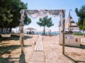 Entrance to golden sandy beach among pines with wooden board path in summer on Thasos island Royalty Free Stock Photo