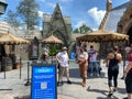 The entrance to the Hagrid`s Magical Creatures Ride at Wizarding World of Harry Potter with people wearing face masks