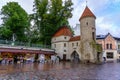 Entrance to the medieval city of Tallinn Estonia with its defensive tower and flower stalls. Royalty Free Stock Photo