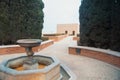 Entrance to medieval moorish fortress Alcazaba in Almeria, gardens and trees and a fountain, Almeria, Andalusia, Spain