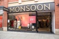 Entrance to Monsoon Fashion clothing store shop showing logo, sign, signage and branding