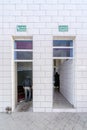 Entrance to the mosque neighboring with entrance to the toilets in Morocco