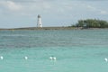 Entrance to Nassau harbour in the Bahamas with old white lighthouse on a breakwater. Royalty Free Stock Photo