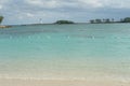 Entrance to Nassau port in the Bahamas with old white lighthouse on a breakwater. Royalty Free Stock Photo