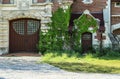 Historic castle, front side. entrance to the old house doors. Castle front with ivy. Royalty Free Stock Photo