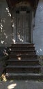 Entrance to an old house with a metal staircase and a beautiful old grunge retro door