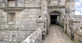 Entrance to an old stone walled castle with portcullis Royalty Free Stock Photo