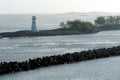 Entrance to the port of Nassau in the Bahamas with old white lighthouse on a breakwater. Royalty Free Stock Photo