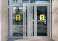 Entrance to retail store with mandatory mask policy signage. Inscription Royalty Free Stock Photo