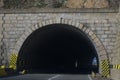 The entrance to a road tunnel that crosses the mountains.