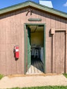 Entrance to a rural campground laundromat with a washer and dryer.